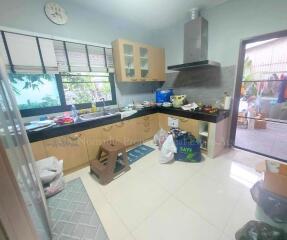 Spacious kitchen with modern cabinetry and large window