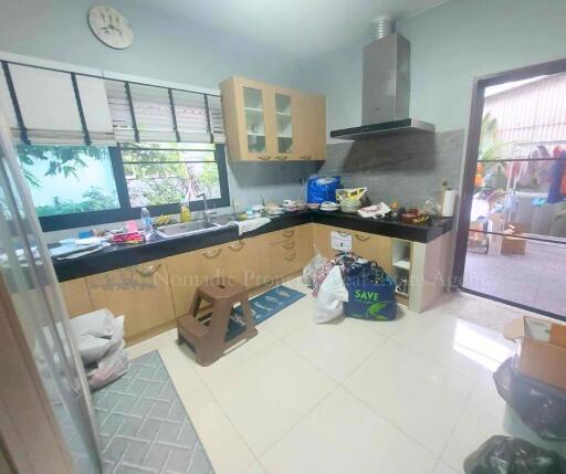 Spacious kitchen with modern cabinetry and large window