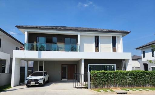 Modern two-story house with a car parked in the driveway