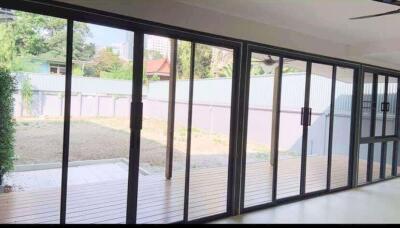 Living room with large glass sliding doors opening to a backyard