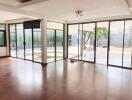 Spacious living room with large windows and a view of the patio