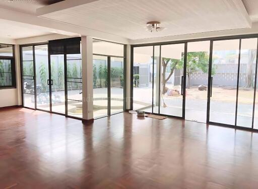 Spacious living room with large windows and a view of the patio