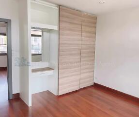 Bedroom with built-in closet and vanity