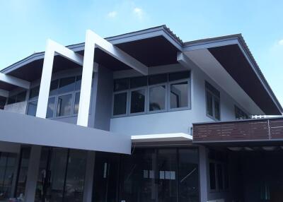 Modern two-story house exterior with large windows and unique architectural design