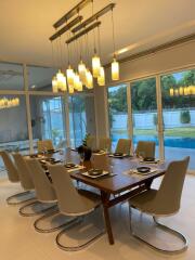 Modern dining room with elegant lighting and pool view