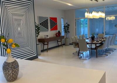 Modern dining area with artistic wall paint and large dining table