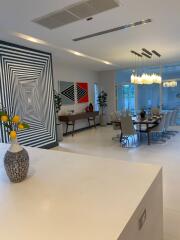 Modern dining area with artistic wall paint and large dining table