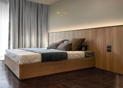 Modern bedroom with wooden bed frame and padded headboard