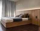 Modern bedroom with wooden bed frame and padded headboard