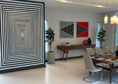 Modern dining area with geometric wall art and elegant table setting
