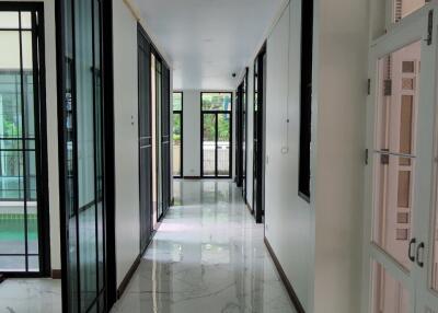 Modern hallway with marble floor and glass doors