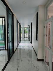 Modern hallway with marble floor and glass doors