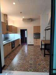 Modern kitchen with wooden cabinets and patterned floor tiles