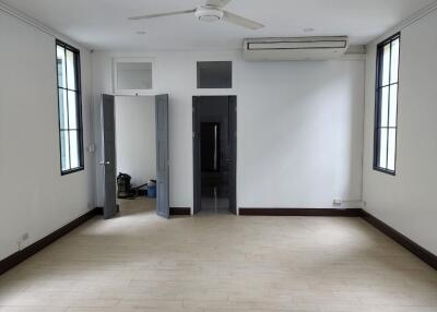 Spacious empty room with ceiling fan and air conditioner