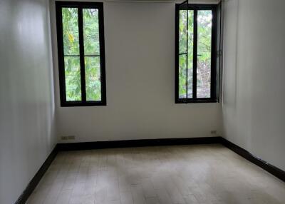 Empty bedroom with two large windows