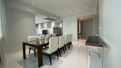 Modern dining room with a long wooden table and upholstered chairs