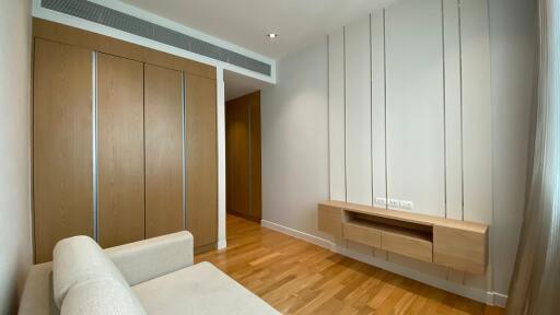 Minimalist living room with wooden floor and built-in storage