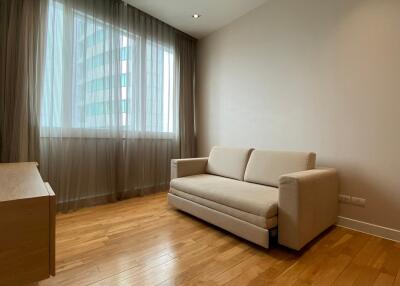 minimalist living room with beige sofa and large window