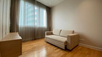 minimalist living room with beige sofa and large window