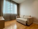 minimalist living room with beige sofa and large window