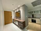 Modern kitchen area with integrated stainless steel appliances and stylish cabinetry.