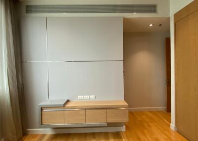 Modern bedroom with built-in storage and wooden floor