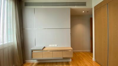 Modern bedroom with built-in storage and wooden floor