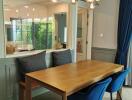 Modern dining area with wooden table and blue chairs