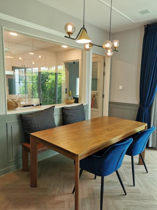 Modern dining area with wooden table and blue chairs