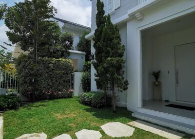 Front exterior view of a two-story house with garden