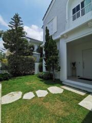 Front exterior view of a two-story house with garden