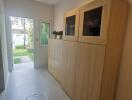 Hallway with wooden cabinets and outdoor view