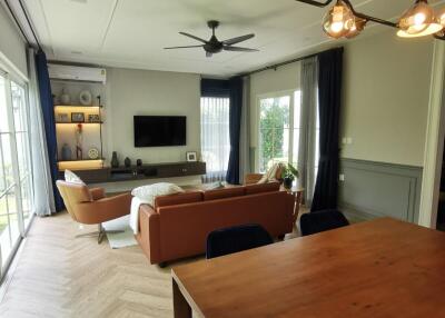 Spacious and modern living room with stylish furniture and large windows.