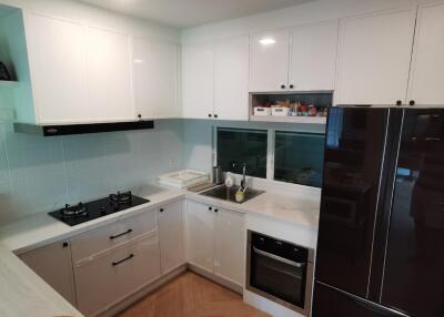 Modern white kitchen with black appliances