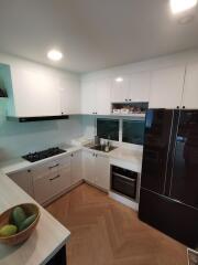 Modern white kitchen with black appliances