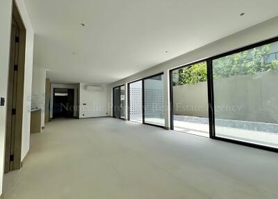 Spacious living room with large windows and abundant natural light