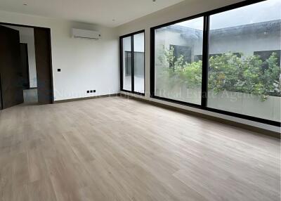 Spacious living room with large windows and garden view