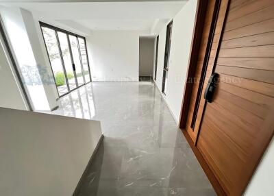 Bright and spacious main living area with large windows and modern flooring