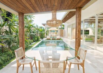 Modern patio area with dining set overlooking a swimming pool