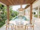 Modern patio area with dining set overlooking a swimming pool