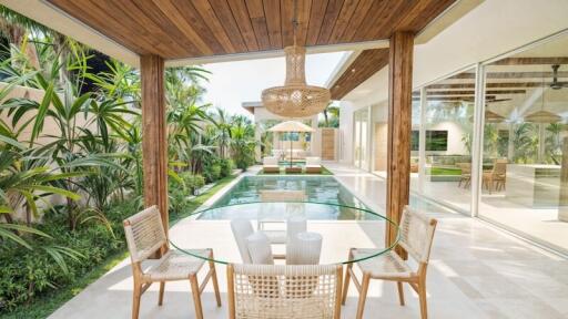 Modern patio area with dining set overlooking a swimming pool