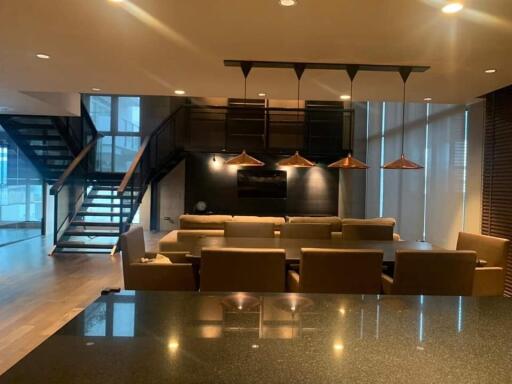 Modern living room with dining area and staircase