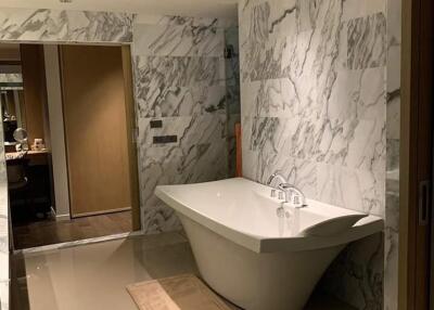Modern bathroom with a large bathtub and marble walls