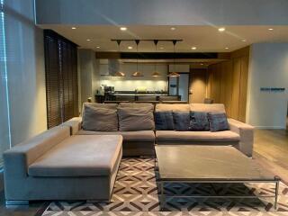 Spacious living room with a modern kitchen in the background