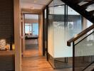 Modern hallway with wooden flooring and a staircase