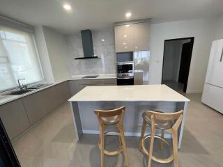 Modern kitchen with island counter and bar stools