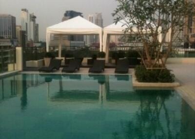 Rooftop swimming pool with lounge area and city view