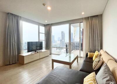 Bright living room with city view, modern furniture, and large windows