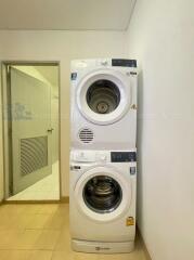 Laundry room with stacked washer and dryer