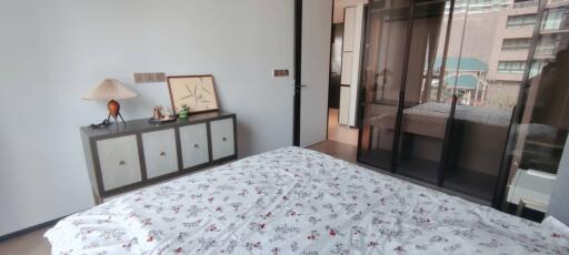 Modern bedroom with a floral bedspread and a dresser